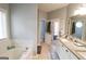Bathroom featuring a dual vanity with granite counters and a garden tub at 416 Line Creek Cir, Sharpsburg, GA 30277