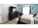 Bedroom featuring a dark wood dresser and a window with decorative wall art at 416 Line Creek Cir, Sharpsburg, GA 30277