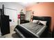Bedroom featuring a queen-sized bed, carpet, closet and decorations on the coral-colored wall at 416 Line Creek Cir, Sharpsburg, GA 30277