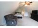 Bedroom with sloped ceiling and carpet and a cozy couch and queen sized bed for comfortable living at 416 Line Creek Cir, Sharpsburg, GA 30277
