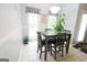 Eat-in kitchen area features a dining table and natural light streaming through large windows at 416 Line Creek Cir, Sharpsburg, GA 30277