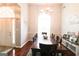 Dining room features tall window, hardwood floors, and chandelier at 416 Line Creek Cir, Sharpsburg, GA 30277