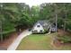 Aerial view of a charming single-Gathering home with a well-manicured lawn and mature trees at 416 Line Creek Cir, Sharpsburg, GA 30277