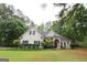Lovely single-Gathering home with a manicured lawn, stone accents, and mature landscaping at 416 Line Creek Cir, Sharpsburg, GA 30277