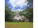 Charming single Gathering home featuring a spacious front yard and beautiful landscaping at 416 Line Creek Cir, Sharpsburg, GA 30277