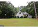 View of the front of this single-Gathering home, with an expansive lawn and a basketball hoop at 416 Line Creek Cir, Sharpsburg, GA 30277
