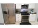 Modern kitchen featuring stainless steel appliances, white cabinets, and granite countertops for a sleek design at 416 Line Creek Cir, Sharpsburg, GA 30277