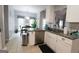 A kitchen that opens to the dining area features granite countertops, stainless appliances, and abundant natural light at 416 Line Creek Cir, Sharpsburg, GA 30277