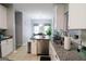 Bright kitchen featuring white cabinets, stainless steel appliances, and granite countertops, open to dining area at 416 Line Creek Cir, Sharpsburg, GA 30277