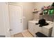 Efficient laundry room with tile floor, washer, and dryer hookups and shelving at 416 Line Creek Cir, Sharpsburg, GA 30277