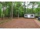 Backyard view of the storage shed and wooded surroundings at 416 Line Creek Cir, Sharpsburg, GA 30277
