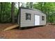 Backyard storage shed with ramp in a wooded setting at 416 Line Creek Cir, Sharpsburg, GA 30277