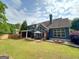 Backyard featuring a large patio, a wooden privacy fence, and lush green grass at 106 Tullamore Trl, Tyrone, GA 30290