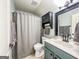 Bathroom featuring a modern single sink vanity with a black framed mirror and updated fixtures at 106 Tullamore Trl, Tyrone, GA 30290
