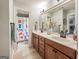 Bright bathroom featuring a double vanity with sleek fixtures and a colorful patterned shower curtain at 106 Tullamore Trl, Tyrone, GA 30290