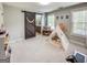 Bedroom with natural light, a decorative teepee, and a modern sliding barn door to the bathroom at 106 Tullamore Trl, Tyrone, GA 30290