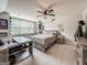 Bedroom with a neutral color scheme, large windows, a ceiling fan, and a wooden bed frame at 106 Tullamore Trl, Tyrone, GA 30290