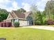 This home has a three car garage with a basketball hoop at 106 Tullamore Trl, Tyrone, GA 30290