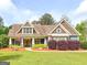 Charming home featuring a manicured lawn and beautiful landscaping at 106 Tullamore Trl, Tyrone, GA 30290