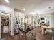 Open-concept kitchen with stainless steel refrigerator, island, and view of the living area at 106 Tullamore Trl, Tyrone, GA 30290