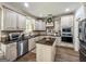 Well-equipped kitchen with stainless steel appliances, granite countertops, and custom cabinetry at 106 Tullamore Trl, Tyrone, GA 30290