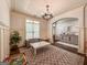 Inviting living room with wainscoting, an elegant chandelier, and a cozy seating area at 106 Tullamore Trl, Tyrone, GA 30290