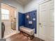 Convenient mudroom with built-in bench, coat hooks, and access to the laundry room at 106 Tullamore Trl, Tyrone, GA 30290