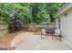 View of backyard with privacy fence, pea gravel walkway, and patio area with chairs at 405 Sherrels Frd, Peachtree City, GA 30269