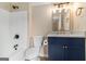 Nicely updated bathroom with blue vanity, granite countertop, and modern fixtures at 405 Sherrels Frd, Peachtree City, GA 30269