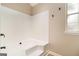 Bright bathroom featuring a clean white tub and shower combination with a window for natural light at 405 Sherrels Frd, Peachtree City, GA 30269