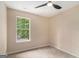 Bedroom with neutral carpeting and paint, with view from window and ceiling fan at 405 Sherrels Frd, Peachtree City, GA 30269