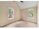 Bedroom with neutral carpeting and paint, vaulted ceiling and views from the double windows at 405 Sherrels Frd, Peachtree City, GA 30269