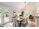 Bright dining room with vaulted ceilings, modern lighting, and access to the backyard at 405 Sherrels Frd, Peachtree City, GA 30269
