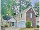 Charming two-story home featuring a mix of brick and stucco, attached garage, and landscaped front yard at 405 Sherrels Frd, Peachtree City, GA 30269