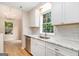 Well-lit kitchen featuring modern appliances, granite countertops, and bright windows at 405 Sherrels Frd, Peachtree City, GA 30269