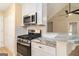Modern kitchen with stainless steel appliances, granite countertops, and a breakfast bar at 405 Sherrels Frd, Peachtree City, GA 30269