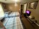 Cozy bedroom featuring two beds with striped bedding and a television at 5172 Avery Sw St, Covington, GA 30014