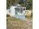 Charming white cottage with a covered front porch and a neatly maintained yard at 5172 Avery Sw St, Covington, GA 30014