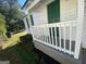 Traditional home featuring a white porch with green door at 5172 Avery Sw St, Covington, GA 30014