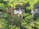 Aerial view of a home nestled among lush trees, showcasing a spacious yard and serene surroundings at 5045 Rock Springs Rd, Lithonia, GA 30038