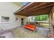 Spacious back deck perfect for outdoor entertaining, with an orange sofa and view of the backyard at 5045 Rock Springs Rd, Lithonia, GA 30038