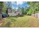 Expansive backyard features a spacious lawn, wooden deck, and a private fence, perfect for outdoor enjoyment at 5045 Rock Springs Rd, Lithonia, GA 30038