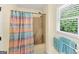 Bathroom featuring a shower-tub combo with stylish shower curtain and window at 5045 Rock Springs Rd, Lithonia, GA 30038