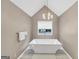 Beautiful bathroom with a modern standalone tub, stylish light fixture, and vaulted ceiling at 5045 Rock Springs Rd, Lithonia, GA 30038