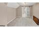 Bright bedroom with neutral carpet, vaulted ceilings, and a view into the bathroom with a sliding barn door at 5045 Rock Springs Rd, Lithonia, GA 30038