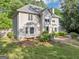 Exterior view of this home showing the side entry garage, large windows, and lush landscaping at 5045 Rock Springs Rd, Lithonia, GA 30038