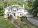 Beautiful home featuring a well-manicured front lawn and charming walkway to a covered front porch at 5045 Rock Springs Rd, Lithonia, GA 30038