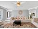 Comfortable living room with a large rug, hardwood floors, and comfortable furniture in an open space at 5045 Rock Springs Rd, Lithonia, GA 30038