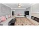 Comfortable living room with a fireplace, hardwood floors, and comfortable furniture in an open space at 5045 Rock Springs Rd, Lithonia, GA 30038