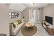 Inviting living room featuring stylish decor, a comfortable sofa, and a view into the bathroom with a barn door at 5045 Rock Springs Rd, Lithonia, GA 30038